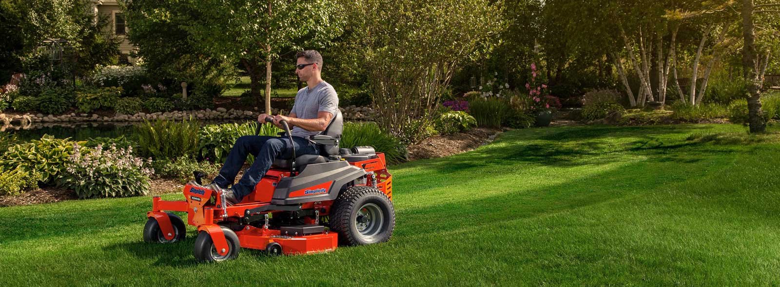 Man using tractor cargo bed for landscaping