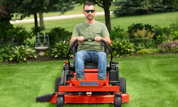 Man mowing the lawn with a Simplicity zero turn mower