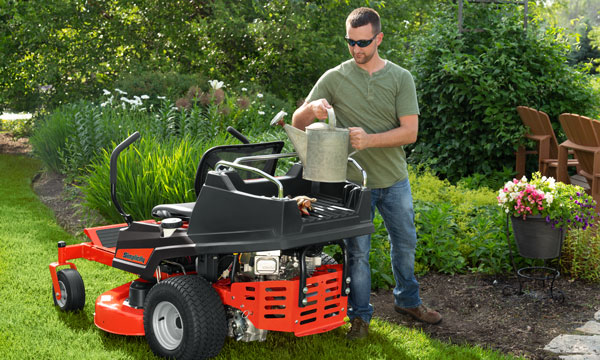 Man utilizing Simplicity zero turn mower cargo bed 